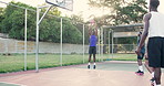 Basketball, court and men playing outside for competitive fun at sunset for health and fitness. Athlete, activity and sport game with friends and people with player teamwork with a ball for cardio