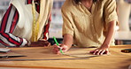 Fashion, drawing and hands of designers in studio with design or pattern template for production. Small business, creative and closeup of women tailors plan and sketch on paper to manufacture clothes