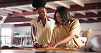 Fashion, sketching and team of designers in studio with design or pattern template for production. Small business, creative and women tailors planning and drawing on paper for manufacturing clothes.