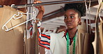 Pattern, woman or tailor at rack in studio for choice, manufacturing or production in startup. Seamstress, fashion designer or African professional with mold on hanger, collection or creative process