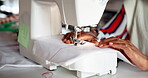 Hands, sewing machine and fabric in studio for fashion manufacturing, small business or production. Person, fingers and equipment in workshop for clothes tailor or ecommerce, pattern or creativity