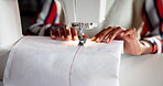 Hands, sewing machine and fabric or manufacturing clothes for small business, production or boutique. Person, fingers and equipment in workshop as fashion tailor or creative pattern, apparel or craft