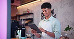 Tablet, ecommerce and man in coffee shop for online order in small business startup as owner or employee. Smile, technology and happy young waiter or barista in cafe for hospitality and service