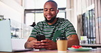 Man, phone and coffee shop with texting, remote work and laptop with reading notification on mobile app. African person, smartphone and happy for social media, web blog or laugh at meme on internet