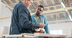 Engineering, teamwork and carpenter with manager in a workshop manufacturing furniture. Woodwork planning, production tools or industrial worker in warehouse talking or speaking of building timber 