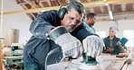 Sanding, wood and carpenter in workshop with tools for production, construction or project. Handyman, building and woodworking process closeup in warehouse with manufacturing or labor in business