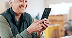 Phone, smile and closeup of woman in workshop networking on social media, mobile app or internet. Happy, technology and mature female carpenter typing email or message on cellphone in warehouse.
