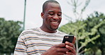 Smile, smartphone and black man typing outdoor at garden, social media or reading funny meme online. Happy, person and scroll on phone at park on internet, laughing and communication on mobile app