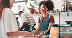 Cashier, cafe food and customer service at counter with thank you, smile for hospitality and drinks order. Happy waitress or barista giving chocolate croissant, pastry or breakfast at a coffee shop