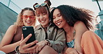 Happy woman, friends and laughing with phone for funny joke, social media or humor in cool outdoor fashion. Female person or group smile in relax on mobile smartphone for online chatting or meme