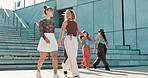 Women, friends and walk in city with gen z people, fashion and conversation in street with trendy style. Girl, chat and happy with edgy clothes, outdoor and urban sidewalk with sunshine in Cape Town