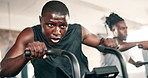 Men, cycling machine and friends in gym for training, wellness and transformation with endurance. African person, exercise bike and stamina with thinking, workout and health for body at fitness club