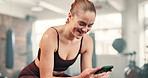 Woman, phone and happy for texting in gym, reading and check notification for contact on mobile app. Girl, person and smartphone for fitness with scroll on web blog, internet chat and social media