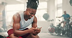 Black man, phone and gym for fitness, workout or training break on social media and chat with health tips or progress. Happy bodybuilder typing on mobile in communication, network or exercise sign up