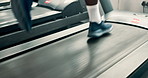 Person, shoes and running on treadmill for cardio, exercise or indoor training at gym. Closeup of runner or athlete legs in fitness on stationary machine or equipment for weight loss at health club