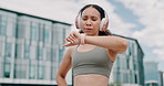 Slow motion video, woman and wearing activewear sports bra . Rose gold headphones , taking a break to restore breath . Viewing the exercise watch in the urban area in the middle of the city 