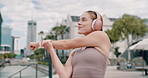 Fitness, stretching and woman with headphones in city for breathing with audio, streaming and subscription. Workout, smile and runner on warm up listening to music, podcast or exercise app in street