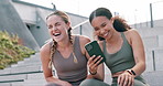 Friends, laugh and happy with phone outdoor for exercise with social media and relax on break at stadium. Fitness, meme and people with funny post about workout or watch video on stairs in city