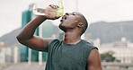 Exercise, running and black man drinking water in city for hydration, rest or recovery from workout. Fitness, street and confident young runner training in urban town with bottle for sports drink