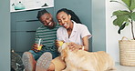 Couple, floor and talking in home with dog, juice and relax together with care, love and bonding. African man, black woman and drink for health, wellness or smile for chat with stroke for pet animal