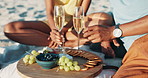 Picnic, alcohol and hands of couple on beach with champagne toast for anniversary, love and date. Nature, food and people with drink, fruit and snack on holiday, vacation and celebration on sand