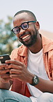 Smile, phone and black man student networking on social media, mobile app or the internet. Happy, technology and young African male person with glasses typing email or message on cellphone in town.