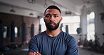Crossed arms, fitness and face of personal trainer in gym for training, exercise and bodybuilder workout. Sports, fitness and portrait of serious man for wellness, focus and commitment for challenge