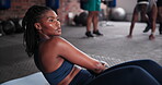 Black woman, medicine ball and fitness for exercise, workout or training on floor at gym. African female person in crunches for muscle, strength or endurance in practice for stamina at health club