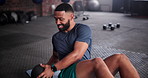 Black man, medicine ball and workout on floor for exercise, training or fitness at gym. Active African male person in crunches for muscle, strength or endurance in practice for stamina at health club