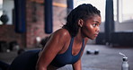 Black woman, push ups and fitness for workout, exercise or training on floor at gym. Active young female person lifting body in sports for muscle gain, arm strength or health and wellness at club