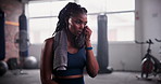 Gym, towel and tired black woman with fitness break, breathing or recovery from intense performance. Sport, burnout or Aftican female athlete sweating from physical challenge, workout or training 