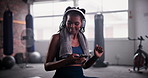 African woman, phone and headphones in gym for music with choice, chat and dancing at training. Person, smartphone and happy dancer with listening to audio streaming subscription with mobile app