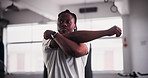 Black man, fitness and stretching for workout, exercise or getting ready for indoor training at gym. Active young African male person in body warm up, stretch or preparation for sports in health club