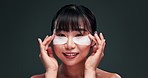 Skincare, eye pads and face of Asian woman in studio with collagen product, facial and beauty routine. Smile, cosmetic benefits and girl with collagen patch for dermatology on dark green background.