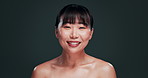 Face, skincare and Asian woman in studio for cosmetics, wellness or treatment results on black background. Beauty, portrait or happy Japanese female model touching glowing skin, dermatology or shine