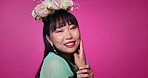 Pink background, happy and face of Asian woman with flower crown for wellness, confidence and skincare. Salon, floral aesthetic and portrait of person for natural, cosmetics and beauty in studio