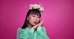 Flower crown, beauty and face of Asian woman in studio for wellness, organic products and skincare. Salon, floral aesthetic and portrait of person with cosmetics, makeup and touch on pink background