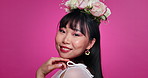 Face, beauty and happy woman with flower crown in hair at studio isolated on a pink background. Portrait, wreath and floral cosmetics of natural Asian model in Korea, organic skin makeup and mockup