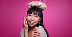 Pink background, beauty and Japanese woman with flower crown for wellness, confidence and skincare. Salon, floral aesthetic and portrait of person for natural face, happy and cosmetics in studio