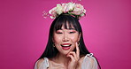 Pink background, makeup and face of Asian woman with flower crown for wellness, luxury and smile. Salon, floral aesthetic and portrait of person for natural beauty, cosmetics and skincare in studio