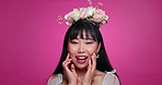 Pink background, beauty and face of happy woman with flower crown for wellness, confidence and skincare. Salon, floral aesthetic and portrait of Asian person for natural cosmetics and glow in studio