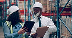 Warehouse, man and woman with a tablet, teamwork and conversation with planning and partnership. Safety, manufacturing or manager with employee or tech with collaboration or industry with digital app