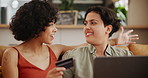 Home, laptop and lesbian couple with a credit card, savings and excited with transactions and budget planning. Queer people, apartment and women with a computer and ecommerce with conversation or app