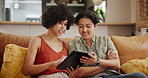 Woman, lesbian couple and tablet on sofa for research, communication or networking in living room at home. Female person, LGBTQ or gay people on technology for online search or chatting at house