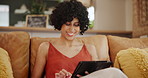 Happy woman, tablet and relax on sofa for networking, social media or communication at home. Female person sitting on living room couch, lounge or smile on technology for online chatting or research