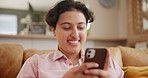 Young woman, typing and phone on sofa for social media, reading website and chat or networking at home. Happy person or online user with mobile communication, texting on internet and couch or lounge