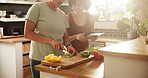 Woman, lesbian couple and cutting vegetables with tablet in kitchen for meal, snack or healthy nutrition at home. Female person, LGBTQ or gay people making food or breakfast with technology on table