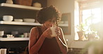 Woman, smelling coffee and aroma on morning, happy and relaxing with hot beverage at home. Female person, thinking and peaceful drink or contemplation on weekend, daydreaming and scent in kitchen