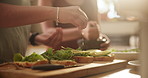 Couple, hands and salt on bread for cooking, seasoning or preparing food, snack or breakfast meal at home. Closeup of hungry people sprinkling spice on lettuce, wheat or sandwich in kitchen on table