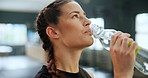 Face, happy woman and drinking water for fitness in gym, healthy body and wellness after training. Club, bottle and thirsty person with liquid beverage for hydration, h2o and nutrition after exercise